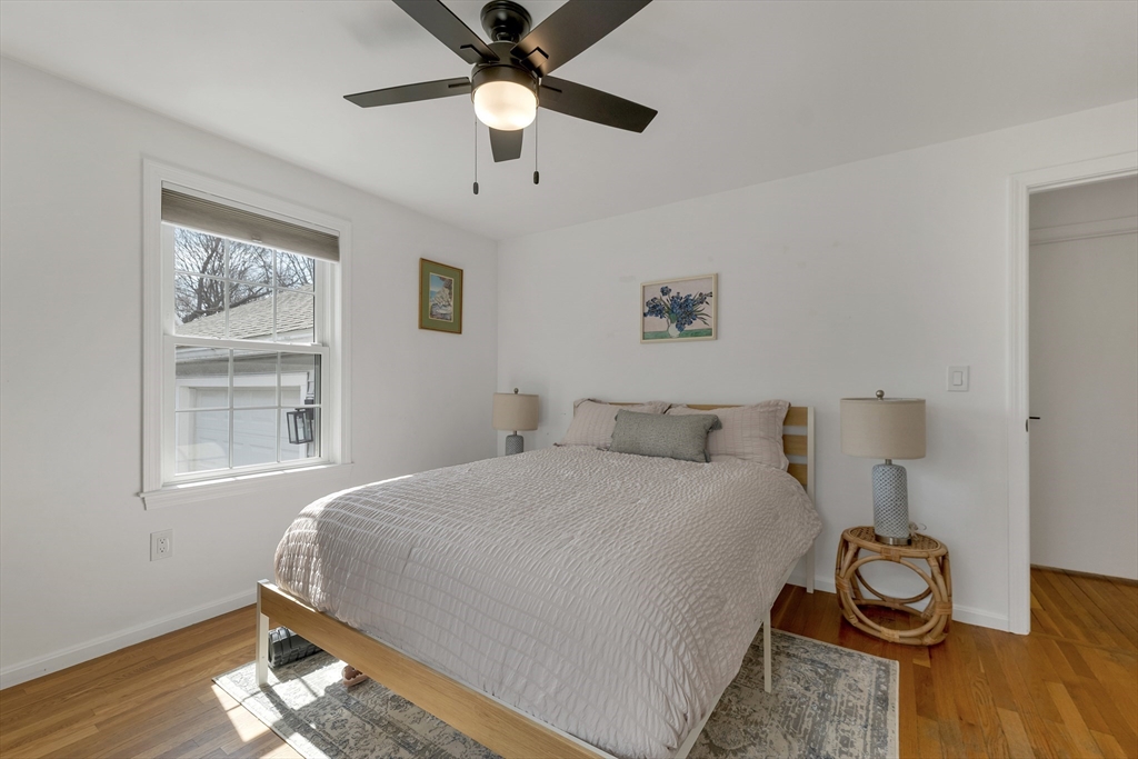 8 Norton Road Hampton, NH 03842 - Photo 14 of 42 a bedroom with a bed and wooden floor