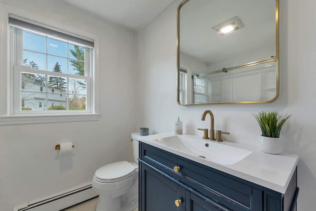 8 Norton Road Hampton, NH 03842 - Photo 17 of 42 a bathroom with a sink vanity and a mirror