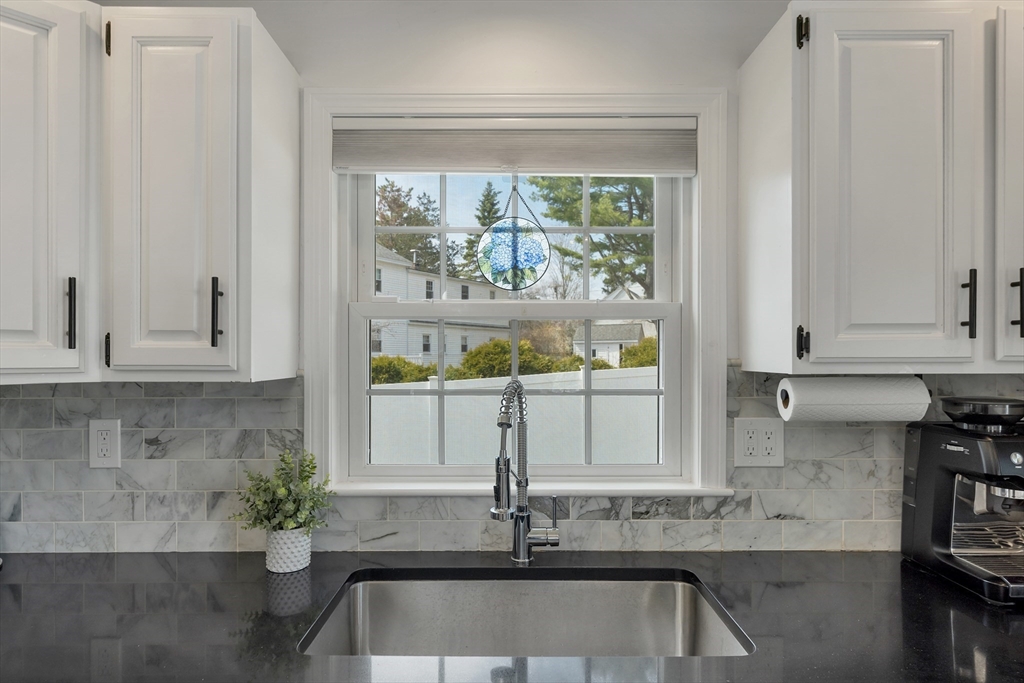 8 Norton Road Hampton, NH 03842 - Photo 6 of 42 a view of kitchen with granite countertop a sink white cabinets and a window