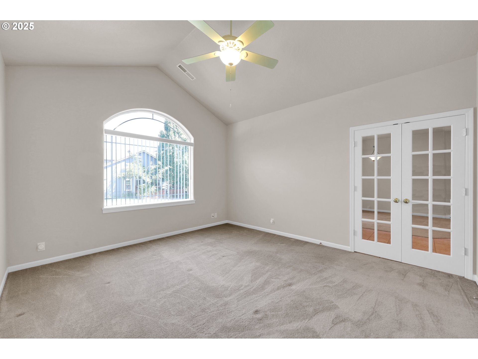 88075 9th Street Veneta, OR 97487 - Photo 10 of 45 an empty room with a chandelier fan and windows