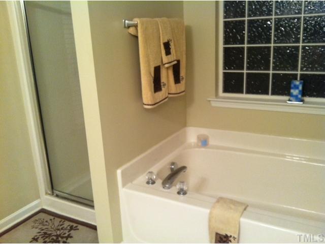 3632 Hamilton Mill Drive Raleigh, NC 27616 - Photo 9 of 12 a bath tub sitting next to a window