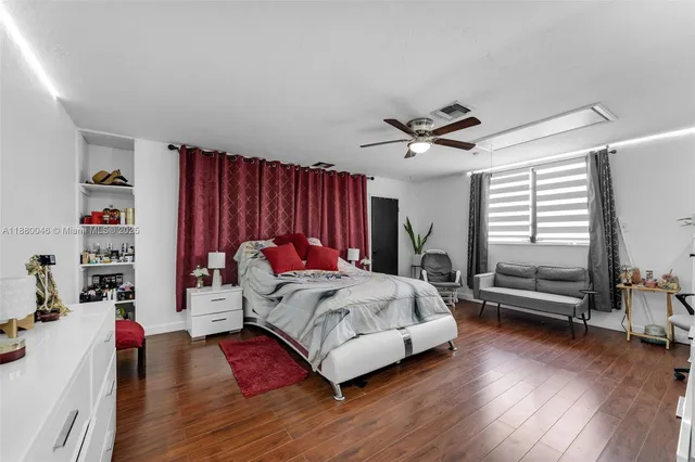 a kitchen with stainless steel appliances a dining table chairs stove and cabinets
