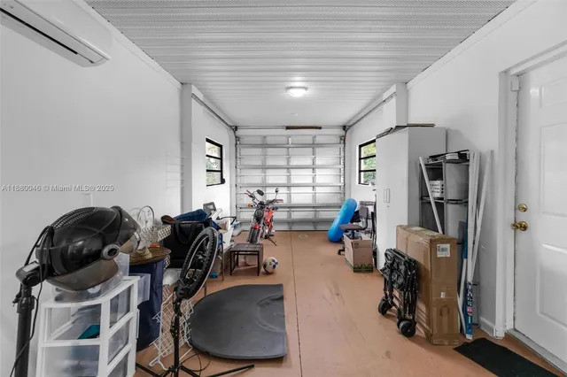 a view of a chair and table in backyard of the house
