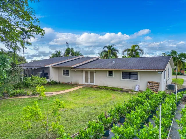 a view of backyard with tub and trees