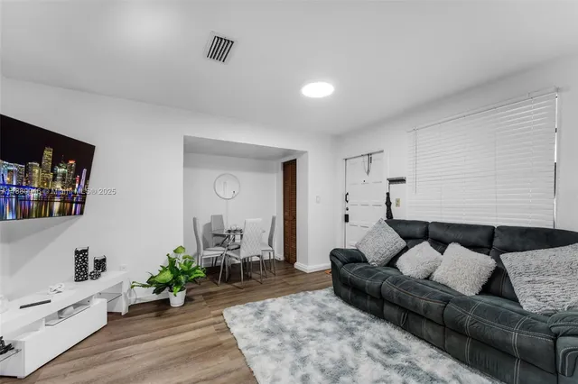 a bedroom with furniture and a flat screen tv