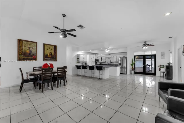 a kitchen with a sink stainless steel appliances and white cabinets