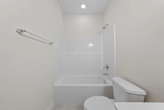 a bathroom with a toilet and a bath tub