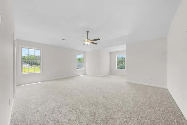 an empty room with windows and closet