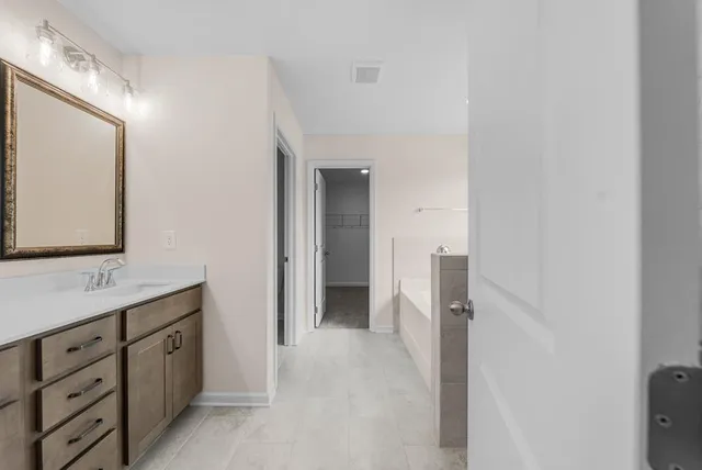 a bathroom with a double vanity sink and mirror