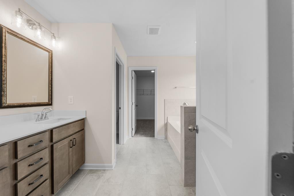 623 Bohannon Road Grantville, GA 30220 - Photo 21 of 34 a bathroom with a double vanity sink and mirror
