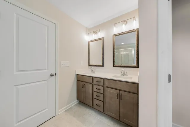 a bathroom with a double vanity sink and mirror