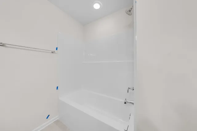 a bathroom with a bathtub and shower