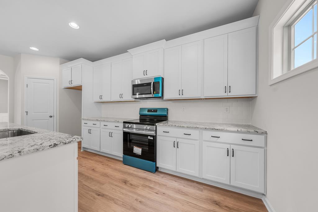 623 Bohannon Road Grantville, GA 30220 - Photo 10 of 34 a kitchen with stainless steel appliances granite countertop a stove a sink and a refrigerator