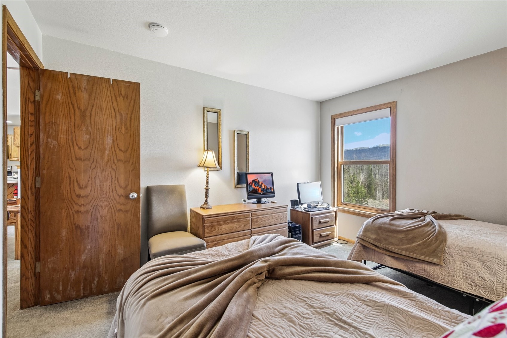 89310 Ryan Gulch Road, Unit 103 Silverthorne, CO 80498 - Photo 12 of 48 a bedroom with two beds and a window