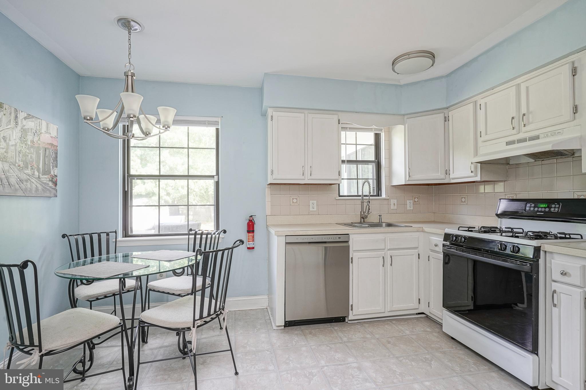 16 Scenic View Drive Sicklerville, NJ 08081 - Photo 8 of 38 a kitchen with stainless steel appliances granite countertop a stove a sink dishwasher a dining table and chairs with wooden floor