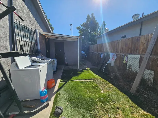 a backyard of a house with yard and outdoor seating