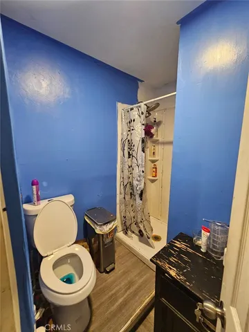 a bathroom with a toilet a sink and a shower