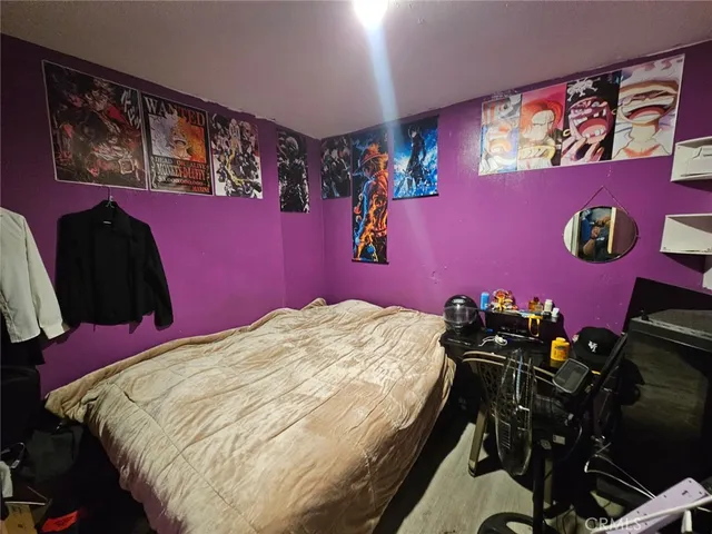 a bed sitting in a bedroom next to a window