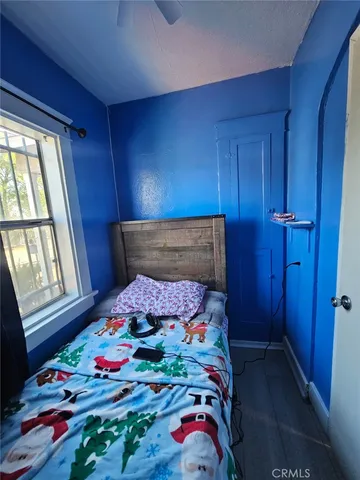 a bedroom with a bed and a dresser in it