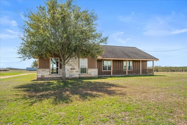 a front view of a house with a big yard
