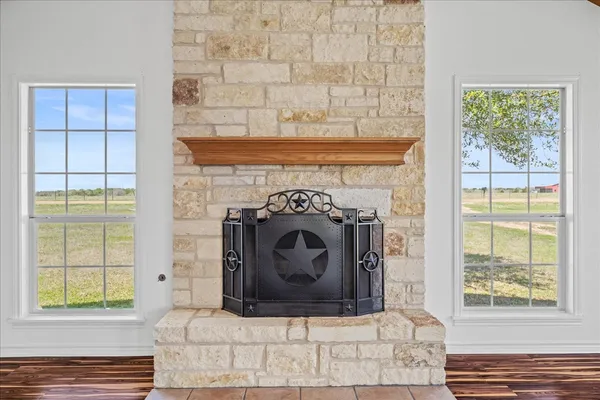 a living room with a fireplace and a window