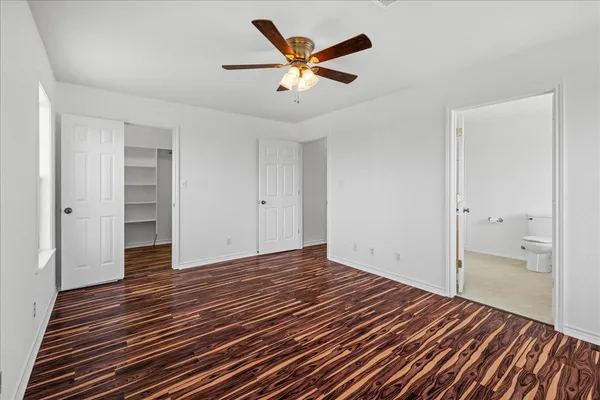 a view of an empty room and wooden floor