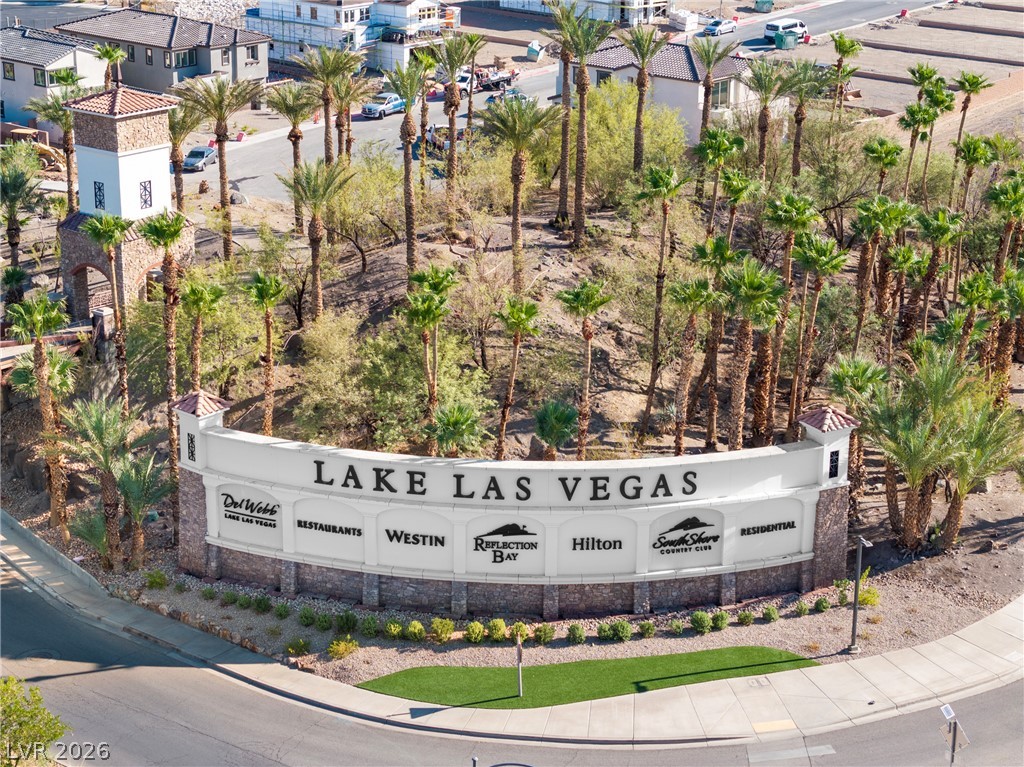 45 Garibaldi Way Henderson, NV 89011 - Photo 63 of 74 An aerial perspective showcases the welcoming entrance to Lake Las Vegas, flanked by mature palm trees and the community's signature monument sign.