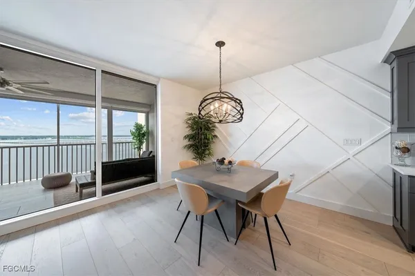 a living room with furniture a dining table and a potted plant