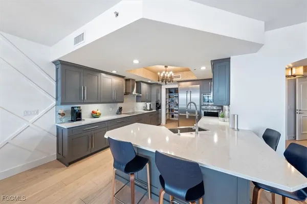a large kitchen with a table and chairs