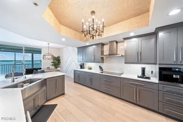 a kitchen with lots of counter top space a sink appliances and cabinets