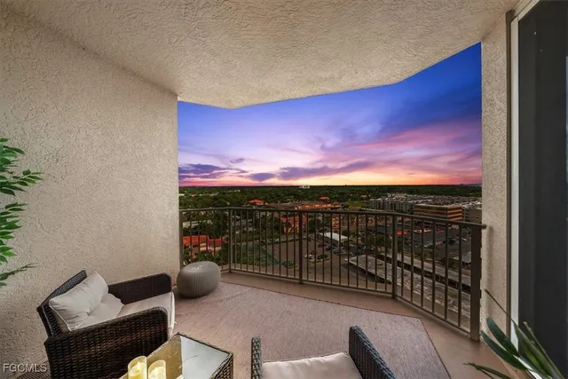 a view of a chairs and table in the balcony