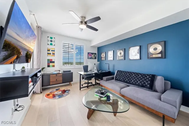 a living room with furniture and a floor to ceiling window