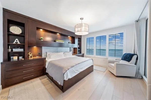 a bedroom with a large bed and a window