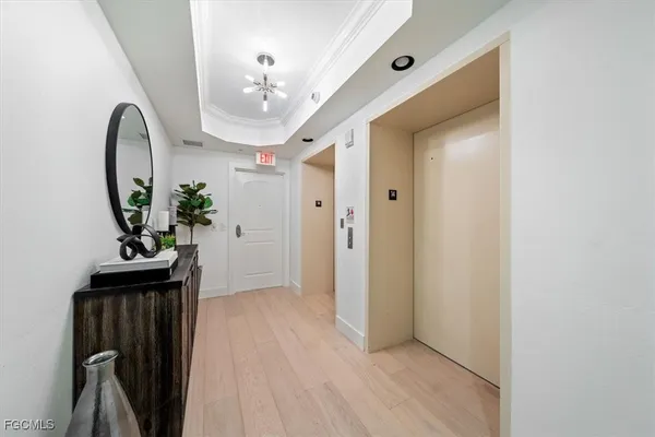 a view of a hallway to a livingroom with furniture
