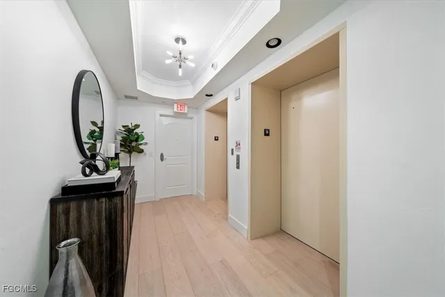 a view of a hallway to a livingroom with furniture