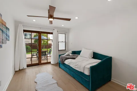 a living room with furniture and large windows