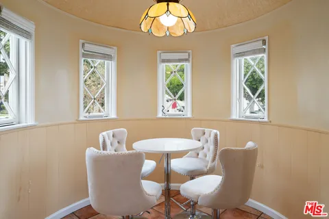 a dining room with furniture and a window
