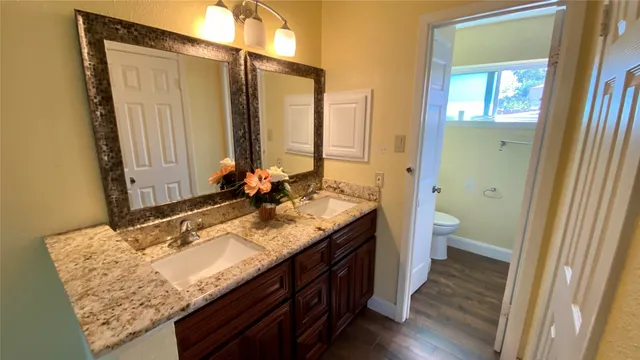 a bathroom with a granite countertop sink mirror and vanity