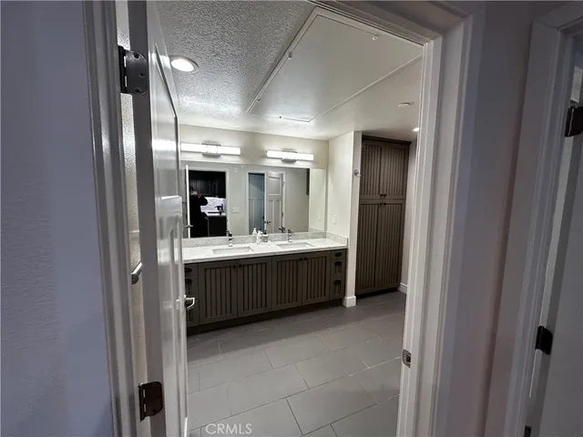a bathroom with a mirror a double vanity sink and mirror