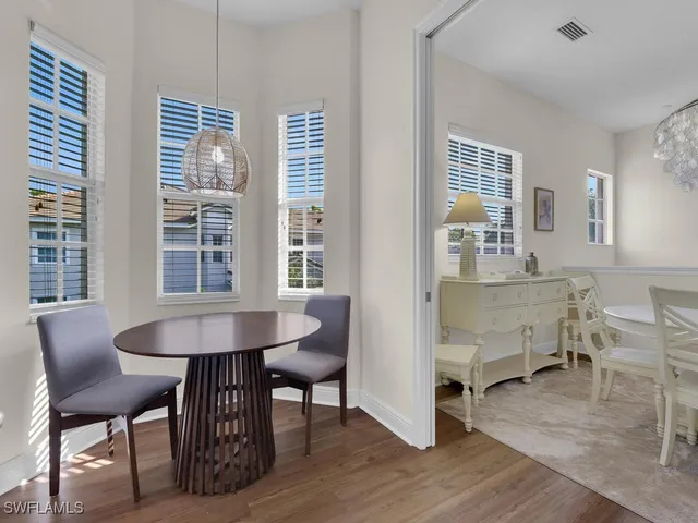 a dining room with furniture and window