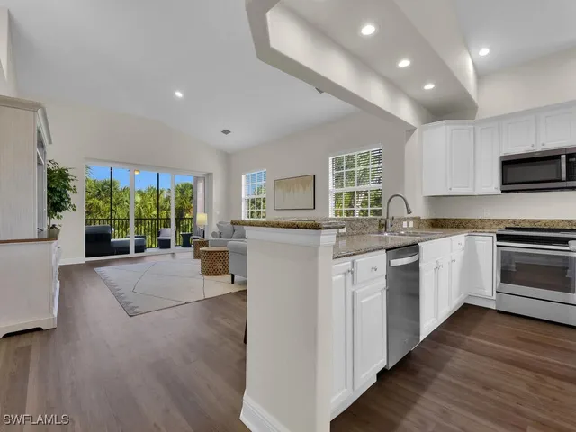 a kitchen with sink a stove and microwave