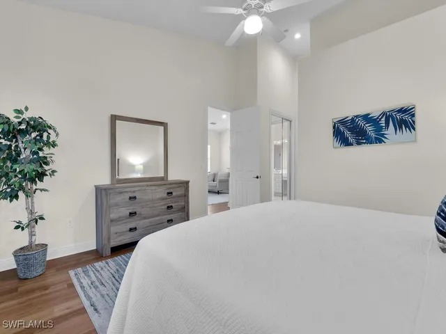 a bedroom with a bed and a potted plant