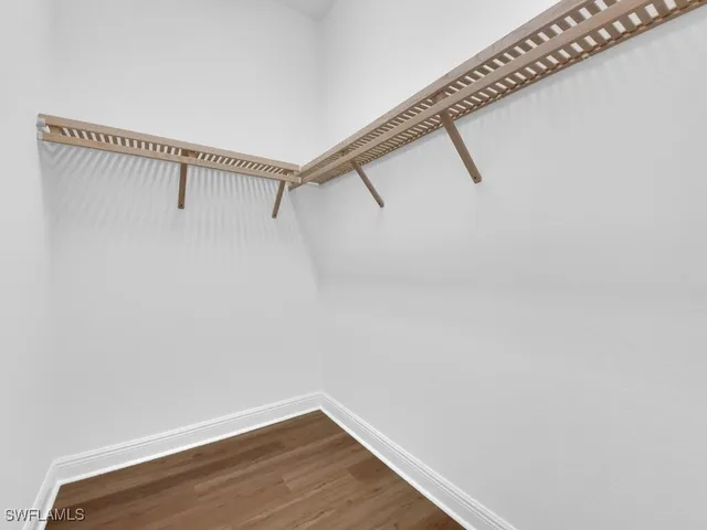 a view of a room with wooden floor and a window