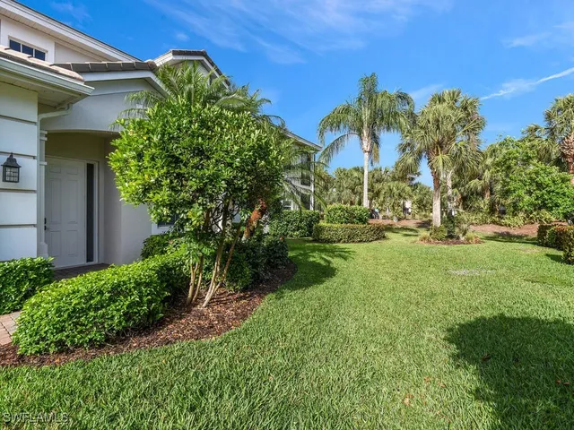 a view of a garden with a building in the background