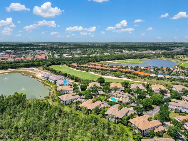 an aerial view of residential houses with outdoor space and trees all around
