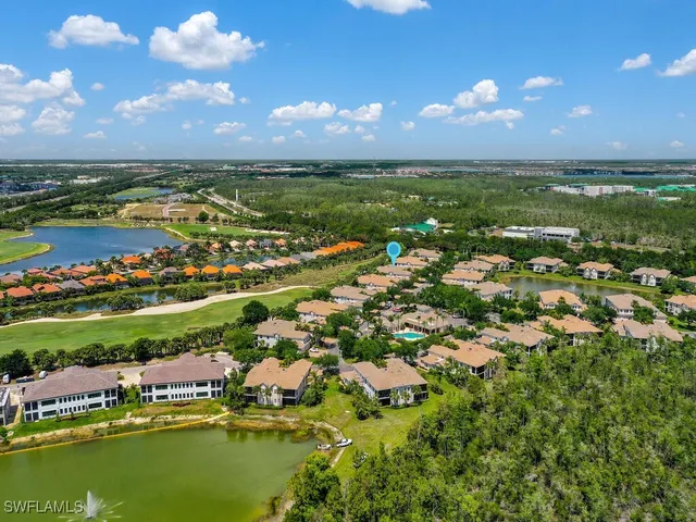 a view of a city with lots of residential buildings lake and ocean view
