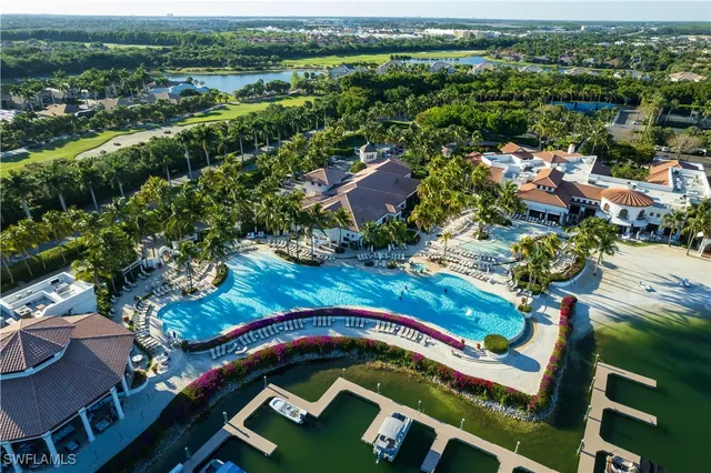 an aerial view of residential houses with outdoor space and pool