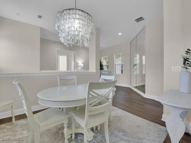 a view of a dining room with furniture and chandelier