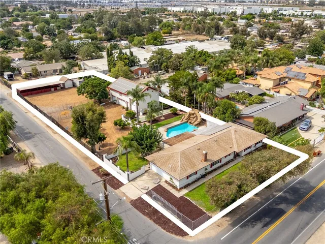 an aerial view of houses with a street