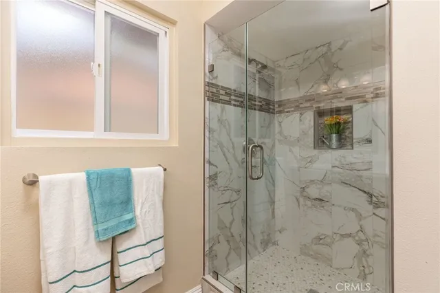 a view of swimming pool with lounge chair and palm trees